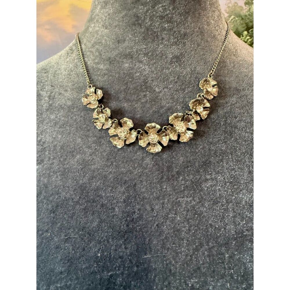 Silver-tone Statement Necklace featuring rhinestone flowers.